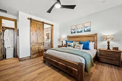 Tastefully decorated with blue and green earth tones and natural textures, this cozy bedroom invites relaxation and tranquility.