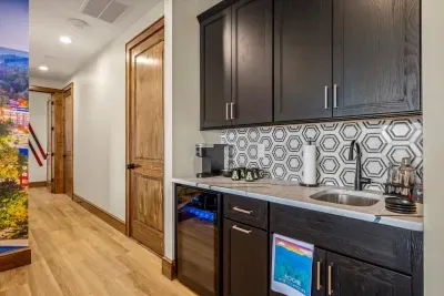 A downstairs mini bar features refrigerator and Keurig coffee machine.  Those staying downstairs don't need to go upstairs for their morning coffee and can walk right out on the deck.