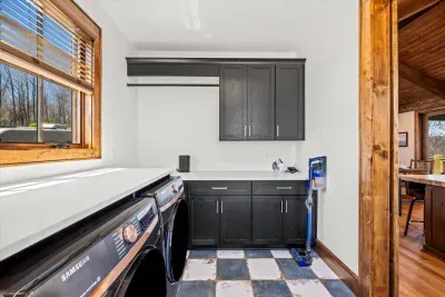 The large laundry room is directly off the kitchen and features an oversized Samsung washer and dryer.  There is also plenty of room to store winter clothes or groceries adjacent to the kitchen.  