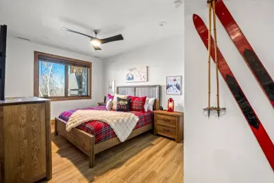 This ski-themed bedroom is ideal for guests visiting the Blue Ridge Mountains.  This professionally designed bedroom features a luxurious Leesa king mattress, rustic timber furniture, and a private ensuite bath.
