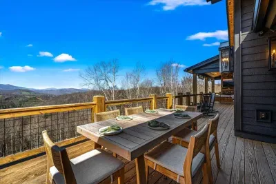 The upper deck also offers outdoor seating at a beautiful teak wood table.