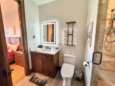 The ski room has an on-suite bathroom that includes heated floors, a lighted mirror, and a Toto Washlets (Bidet) complete with a heated seat.