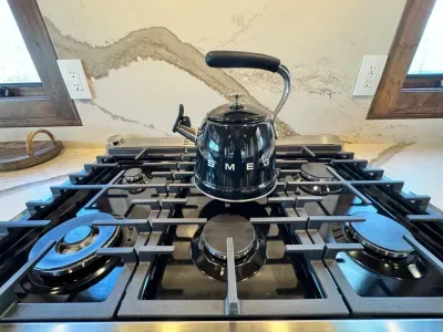 A stylish Smeg tea kettle is available for your use.