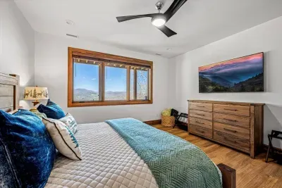 All four bedrooms offer a gorgeous view of the Blue Ridge Mountains.  This bedroom also offers a 65" Smart TV, a large dresser, and two nightstands with many charging outlets.