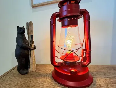 This cozy bedroom, inspired by the thrill of mountain adventures,  includes red lanterns for bed table lamps.

