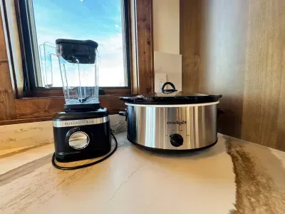 Fully stocked with all the kitchen essentials for enjoying a meal with family and friends including a Kitchen Aid blender and Crockpot.