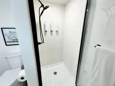 Walk-in shower with removable shower wand.