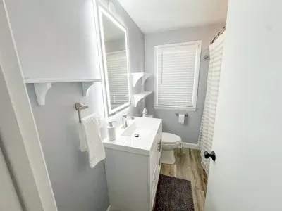 Full bathroom on main floor with plenty of shelving space and additional linen closet inside.