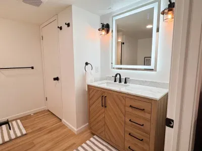 A brand new bathroom with lots of space and a hotel quality lit mirror with anti-fog.  