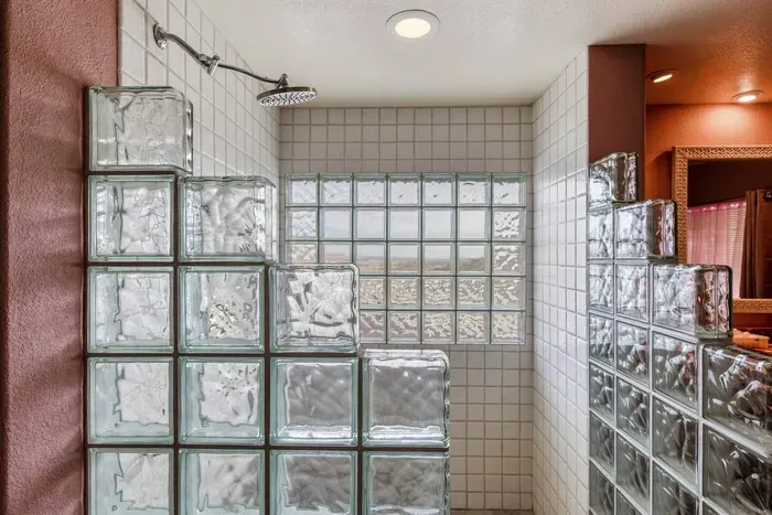 Large walk-in glass shower with views of Joshua Tree while maintaining privacy.