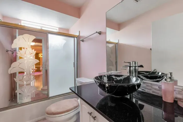 The guest bathroom, located between the Cloud and Aqua rooms features a funkadelic vintage etched mirrored shower door.