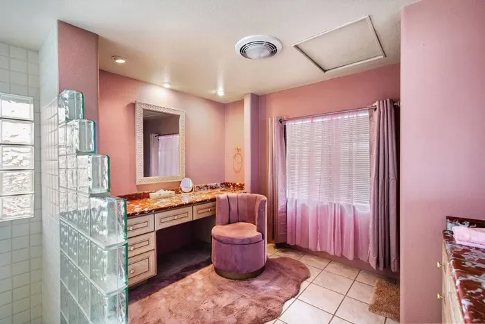 Master en-suite bathroom with oversized retro glass block shower and large vanity. Looo-king Gooood!