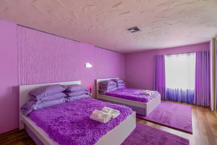 With 2 Queen beds, shagadelic fluffy blankets and beaded headboard accents, the Cloud Room is a smashing place to kick back and relax.