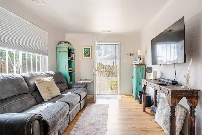 Comfortable living room inside Cozy Casita in Rental B with recliner seating on both sides of the couch for comfort and relaxation while watching ROKU Television 