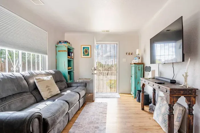 Comfortable living room inside Cozy Casita in Rental B with recliner seating on both sides of the couch for comfort and relaxation while watching ROKU Television 