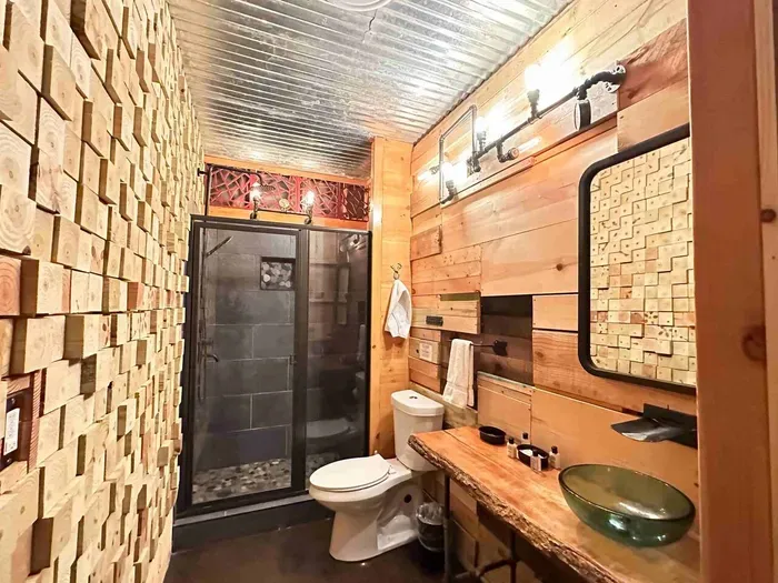 Custom basement bathroom hosts a walk in shower.