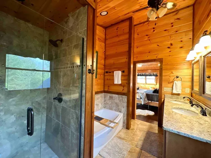 Upstairs primary bathroom has custom walk in shower & soaking tub.