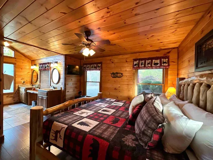 Main level primary room hosts a King bed with custom walk in shower.