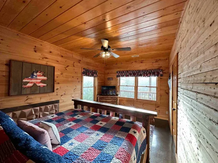 Basement bedroom hosts a comfy queen bed.