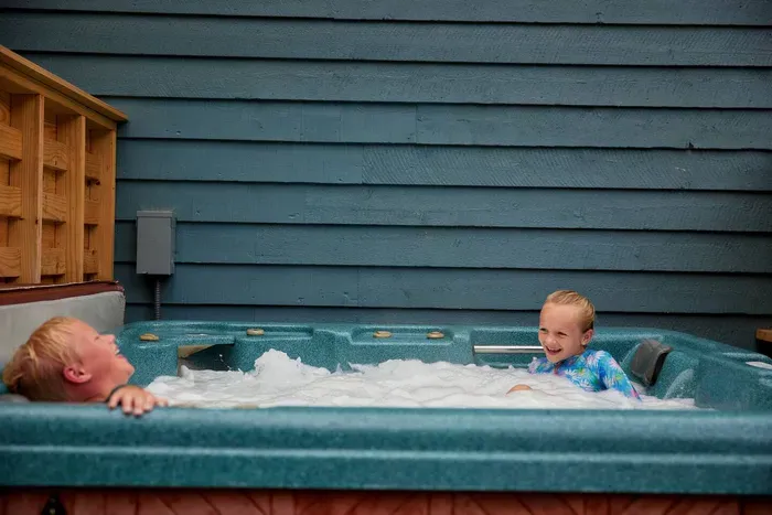 Fun-filled moments and laughter abound as families enjoy the jacuzzi together. 