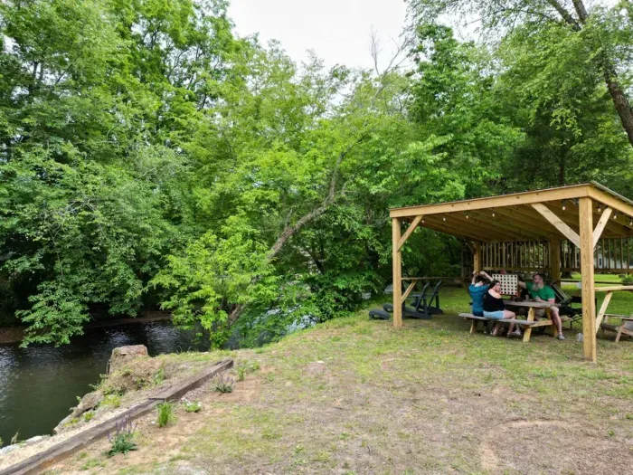 Experience a friendly gathering by the river, a perfect setting for catching up and enjoying each other's company.