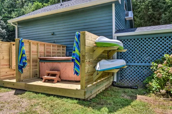 Take in the view of the expansive backyard and river while relaxing in the hot tub 