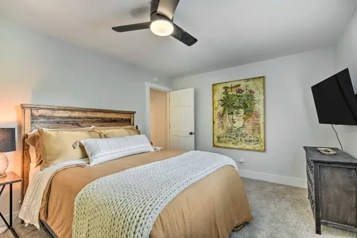 Indulge in comfort and style in your charming queen bed guest bedroom, featuring a smart  TV and a  luxury design. Relax and unwind in this delightful space, offering a perfect blend of simplicity and elegance for a restful stay.