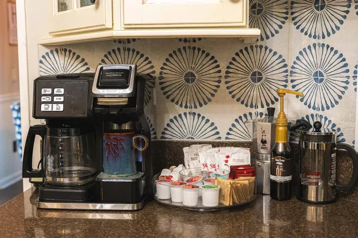 Coffee maker brews ground coffee & K-cups. French press & percolator available also.