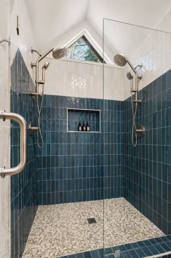 Relax and recharge in this spacious, sunlit shower with dual rain heads and calming, spa-inspired design
