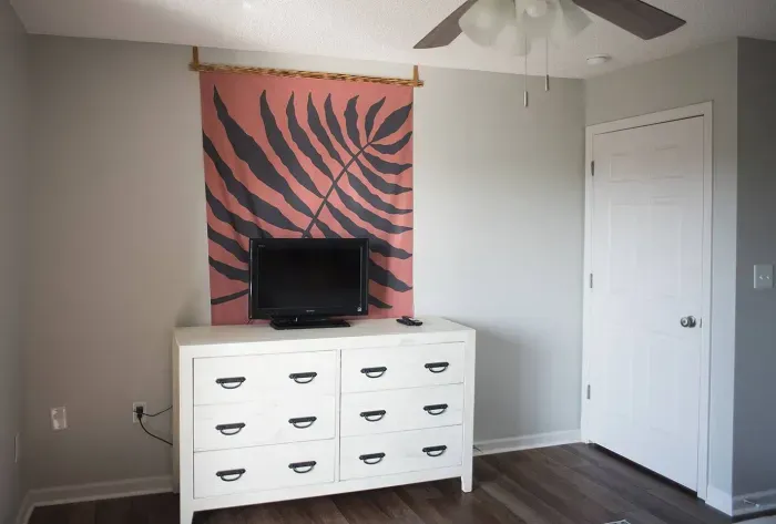Bedroom entertainment: A cozy TV perched on a multi-door cabinet shelf, providing convenience and storage in style