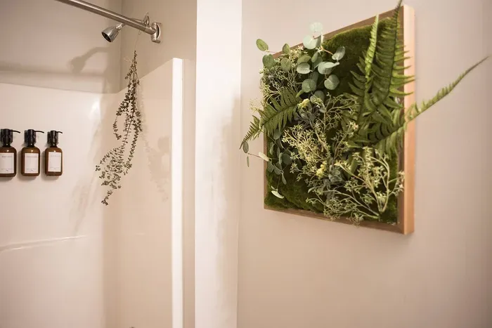 Living artwork: A captivating display of real greens artfully planted on a frame, bringing nature's beauty to adorn the walls of our bathroom