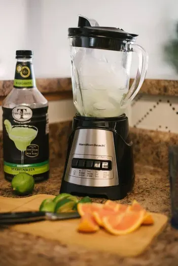 Blend your way to freshness: A juice blender and cutting board are at your disposal, making it easy to create refreshing, homemade fruit juices in this culinary haven