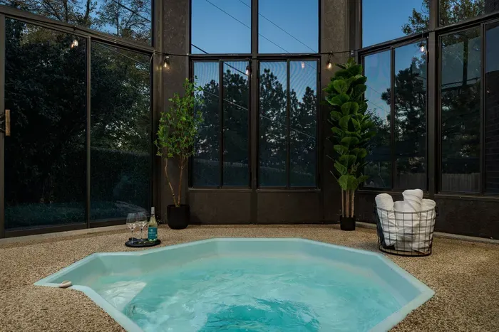 The hot tub is accessible from the master bedroom as well as the backyard and is enclosed for all-season use.