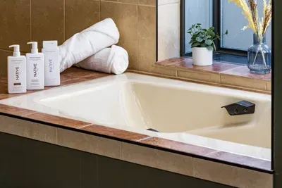 Take a relaxing bath in the master bedroom. This bath is en suite in a master bedroom on the top floor.