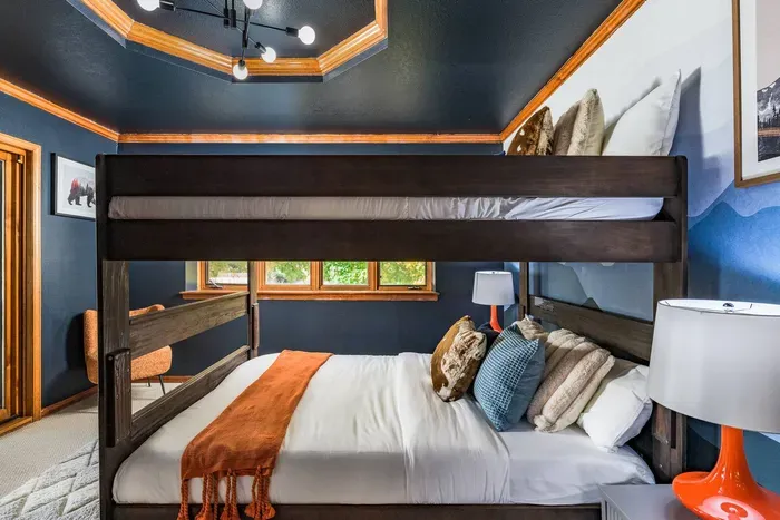Bunk bed, bedroom with access to the outdoor deck and a door leading directly into the kitchen area. Bedroom faces the street.