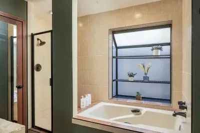 Full tub and shower combination in suite in the master bedroom on the first floor.