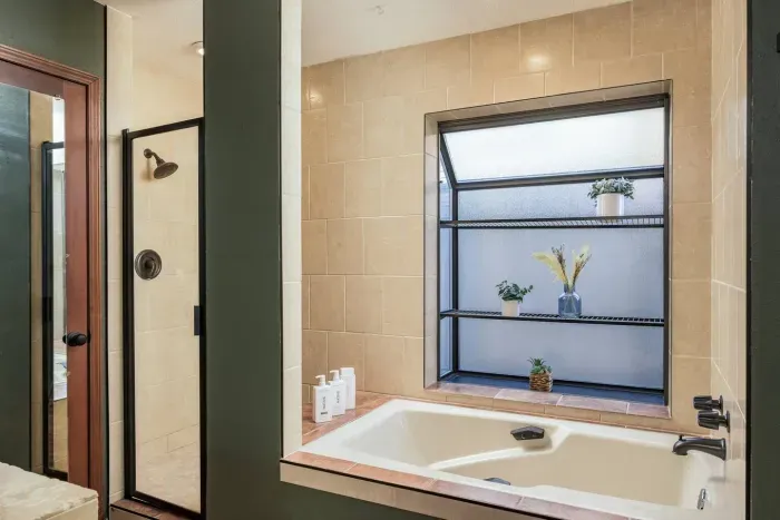 Full tub and shower combination in suite in the master bedroom on the first floor.
