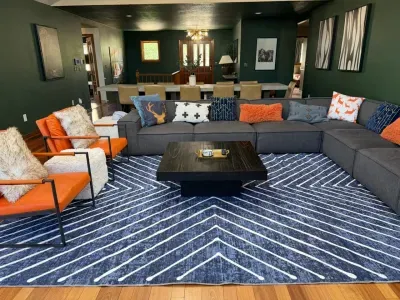 Spacious designer living room with large sectional and bold modern style