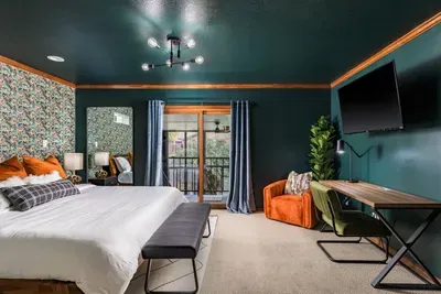 Master bedroom with workstation, access to the hot tub, and in-suite bathroom.