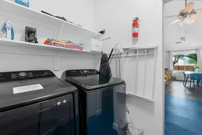 Laundry room with brand new full sized washer and dryer