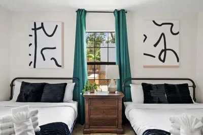 Bedroom 1- 2 queen beds looking out towards the pool