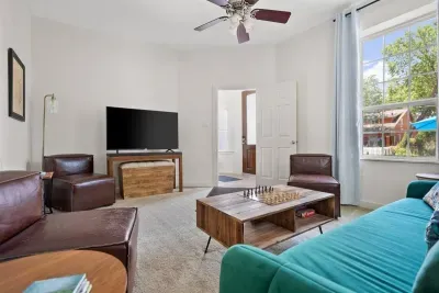 Living room (the green couch has been replaced by a tan queen sleeper sectional)