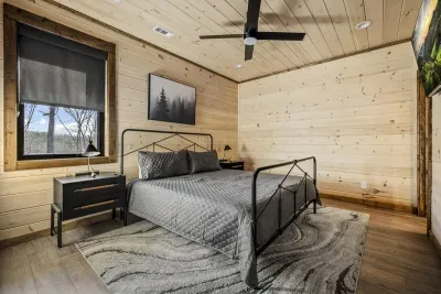 Rustic bedroom with wood finishes, forest views, and modern design.