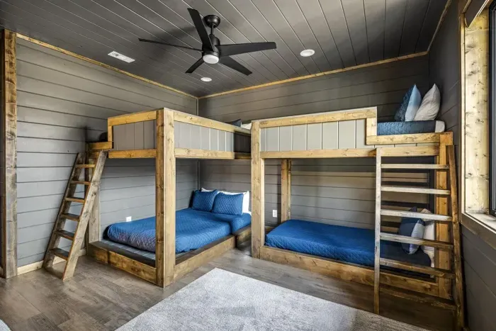 Spacious bunk room with L-shaped layout and natural light.