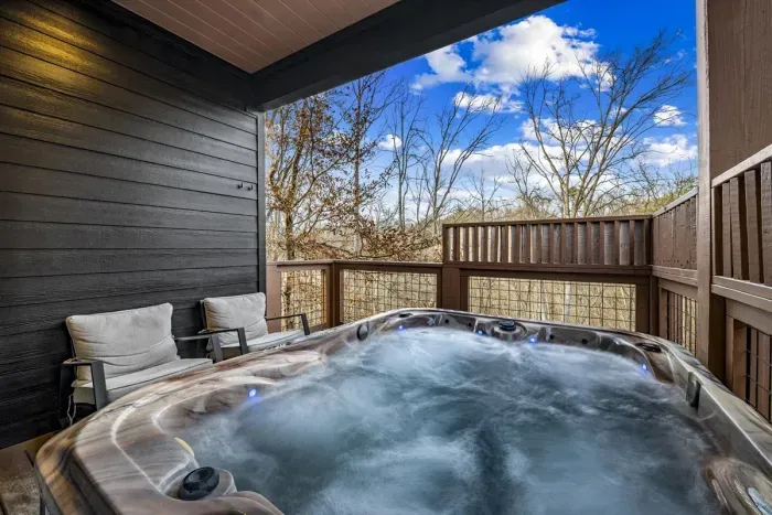 Unwind in the bubbling hot tub with forest views.