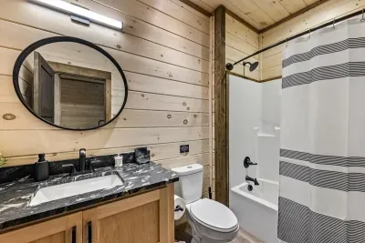 Forest mist, and matte black vibes, this bathroom’s got character.