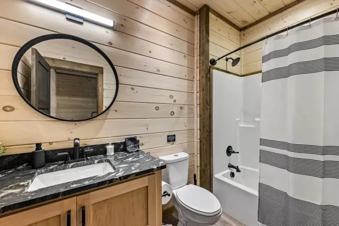Forest mist, and matte black vibes, this bathroom’s got character.