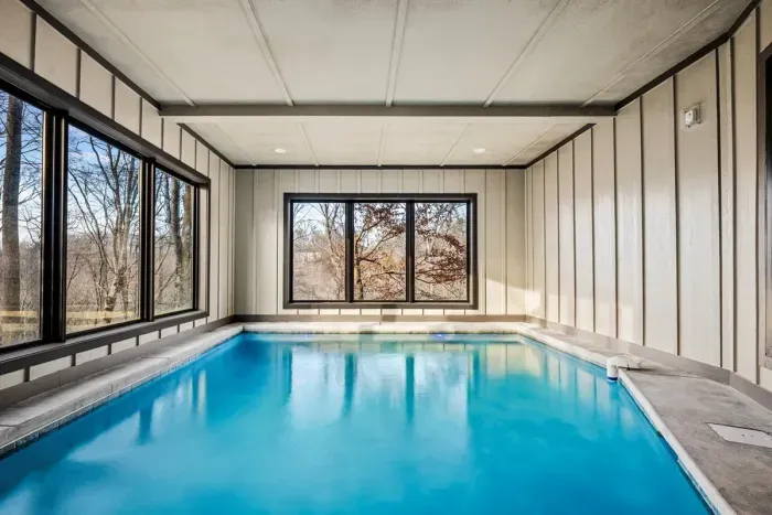 Climate-controlled indoor pool with forest views.