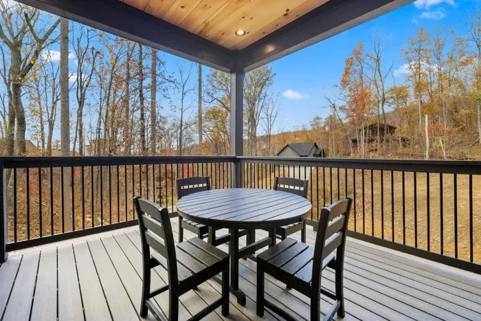 Outdoor seating area overlooking wooded area