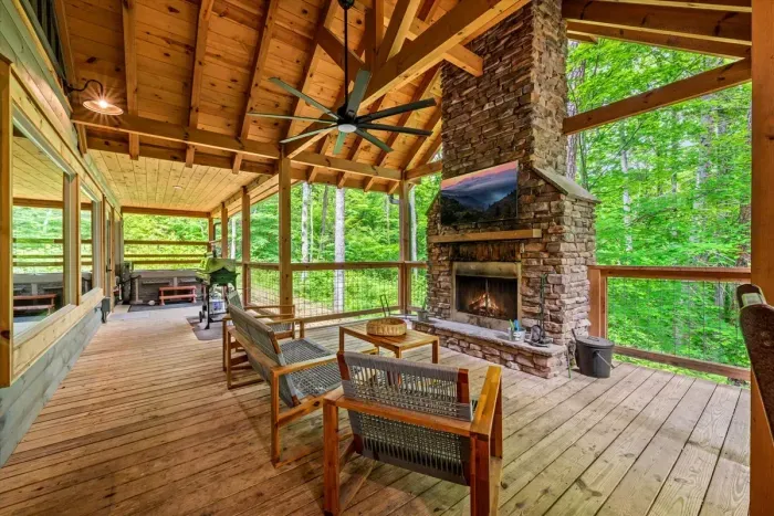 Large deck with ample seating, fireplace, TV and hot tub